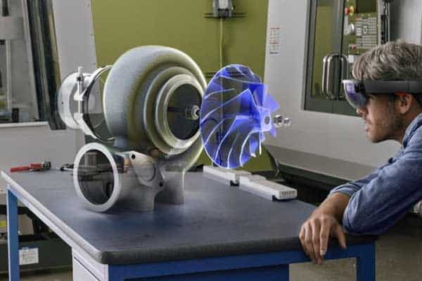 Engineer using augmented reality headset to view a digital prototype