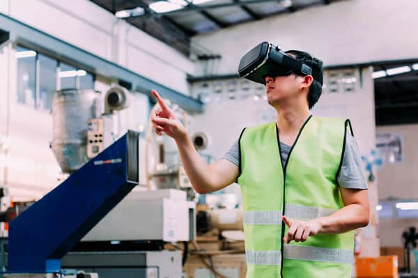 manufacturing and construction vr training Man in yellow work vest using a virtual reality headset